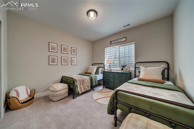 carpeted bedroom featuring baseboards and visible vents