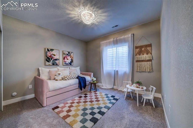 sitting room with carpet floors, baseboards, and visible vents