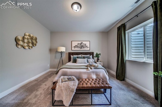 carpeted bedroom featuring baseboards and visible vents