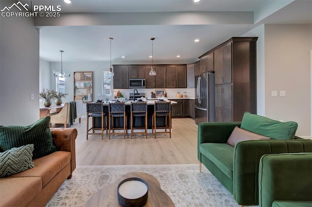 living area featuring light wood-style floors and recessed lighting