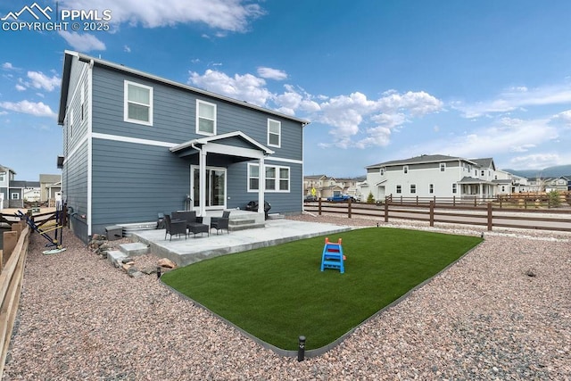 2186 Prairie Smoke Dr, Monument, CO 80132 - back of property with a fenced backyard, a patio, a yard, and a residential view