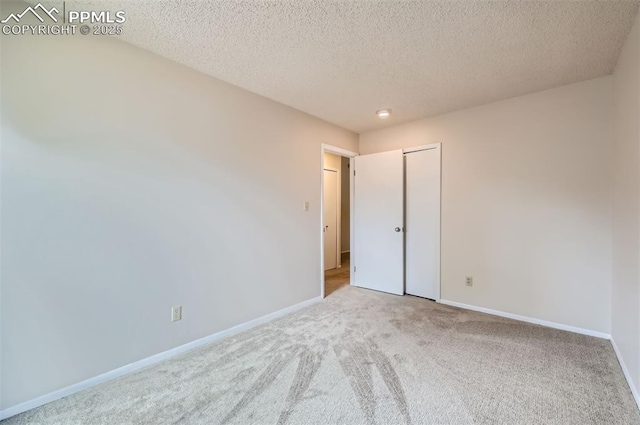 2903 E Serendipity Cir, Colorado Springs, CO 80917 - unfurnished bedroom with carpet floors, baseboards, a textured ceiling, and a closet