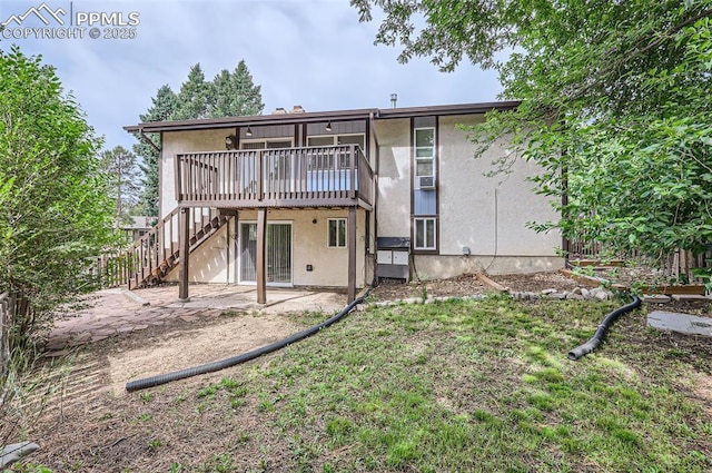 2903 E Serendipity Cir, Colorado Springs, CO 80917 - rear view of property featuring a deck, stucco siding, stairs, and a patio area