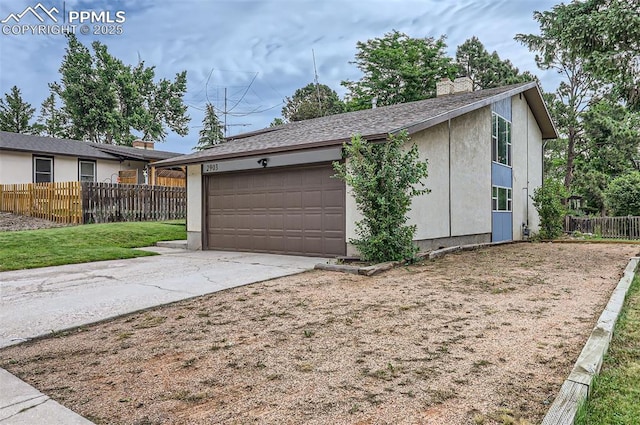 2903 E Serendipity Cir, Colorado Springs, CO 80917 - garage featuring fence and concrete driveway