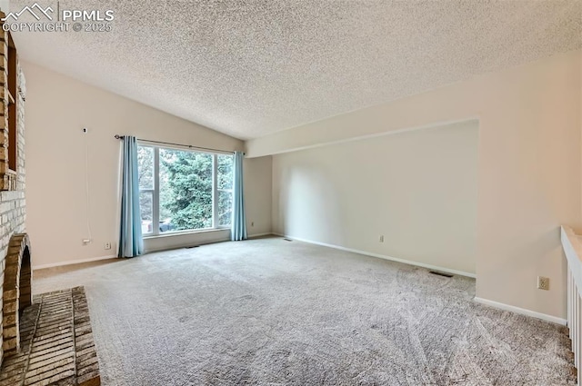 2903 E Serendipity Cir, Colorado Springs, CO 80917 - unfurnished living room with a textured ceiling, carpet, vaulted ceiling, and baseboards