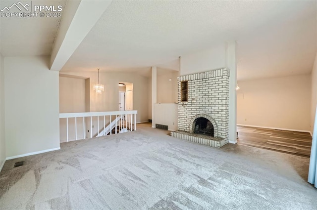 2903 E Serendipity Cir, Colorado Springs, CO 80917 - unfurnished living room featuring carpet, a chandelier, baseboards, and a fireplace
