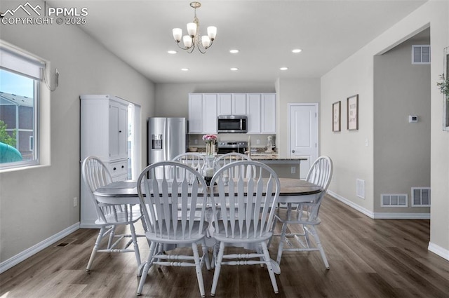 dining area featuring baseboards, wood finished floors, and visible vents