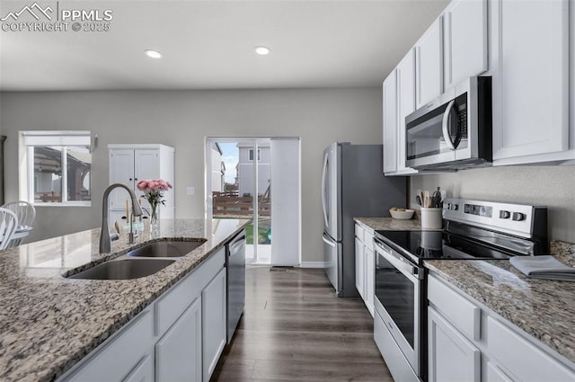 kitchen with a sink, appliances with stainless steel finishes, and white cabinets