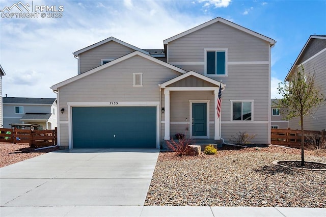 traditional-style home with concrete driveway, an attached garage, and fence