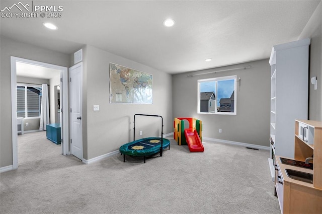 recreation room featuring baseboards, carpet, recessed lighting, and visible vents