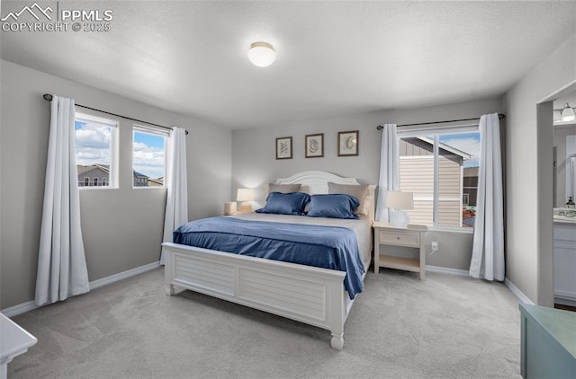 carpeted bedroom featuring baseboards and multiple windows