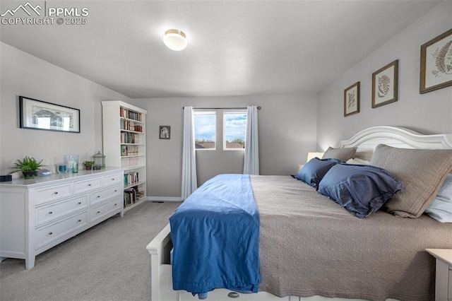 bedroom featuring baseboards and light carpet
