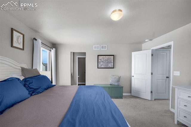 bedroom featuring visible vents, baseboards, and light carpet