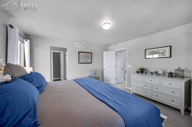 bedroom featuring baseboards, visible vents, and light carpet