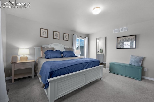carpeted bedroom with baseboards, ensuite bathroom, and visible vents