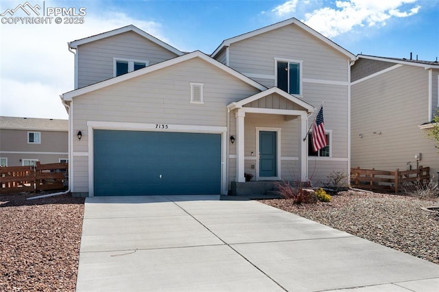traditional-style home featuring concrete driveway, an attached garage, fence, and board and batten siding
