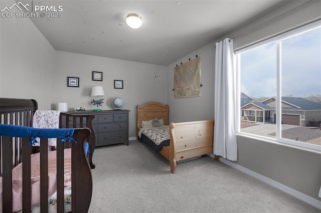 bedroom featuring baseboards and carpet
