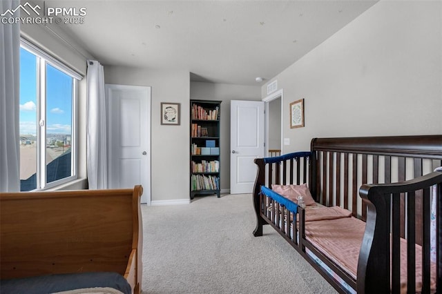bedroom with light colored carpet, baseboards, and visible vents