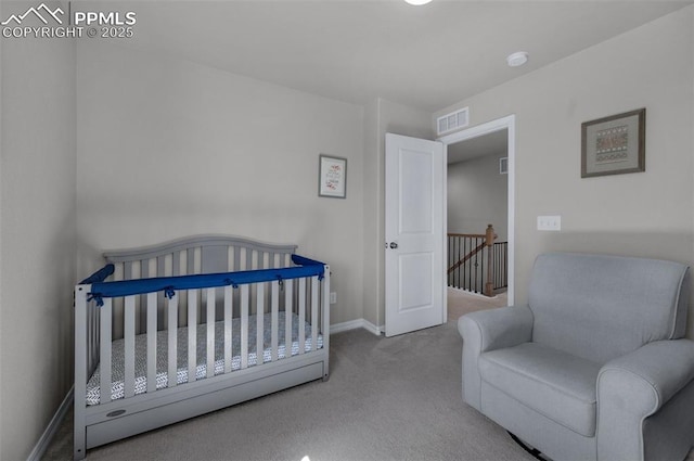 carpeted bedroom featuring visible vents and baseboards