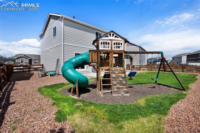 view of playground with a lawn and a fenced backyard