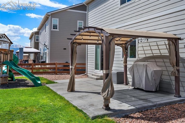 back of property with a patio, a playground, and fence