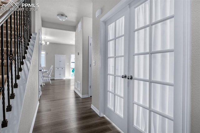foyer entrance with baseboards and dark wood-style floors