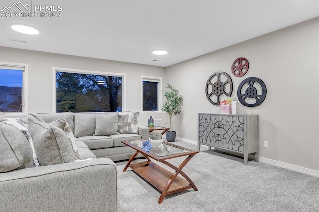 carpeted living area with baseboards and visible vents