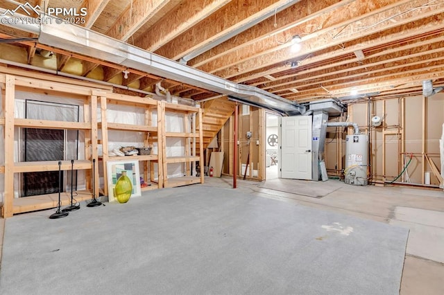 unfinished below grade area with stairway and gas water heater