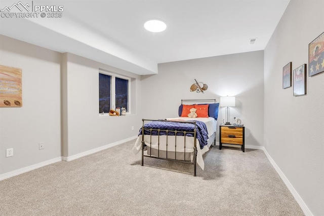 bedroom featuring baseboards and carpet