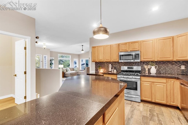 kitchen with light brown cabinets, backsplash, stainless steel appliances, and open floor plan