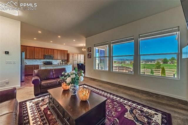 carpeted living area with baseboards, visible vents, and recessed lighting