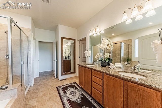 bathroom featuring a sink, double vanity, a stall shower, and visible vents