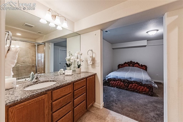 bathroom with tile patterned floors, vanity, visible vents, and a stall shower