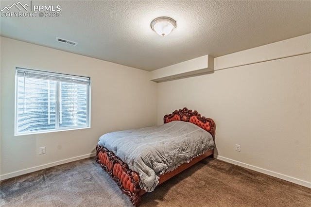 carpeted bedroom with baseboards, visible vents, and a textured ceiling