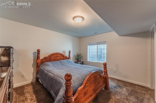 bedroom with a textured ceiling, visible vents, baseboards, and dark carpet