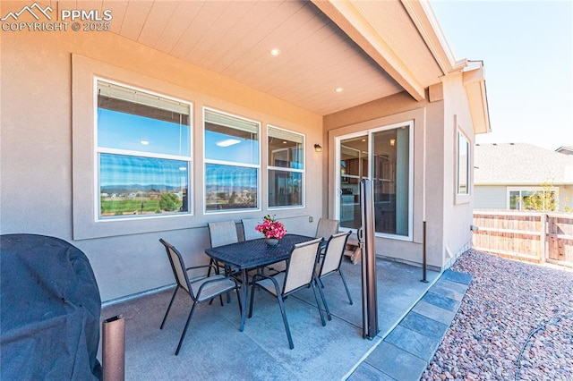view of patio featuring fence and outdoor dining space