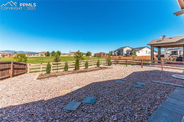 view of yard with a residential view and a fenced backyard