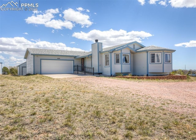 6185 Sayres Rd, Colorado Springs, CO 80927 - ranch-style house featuring an attached garage, a front yard, driveway, and a chimney
