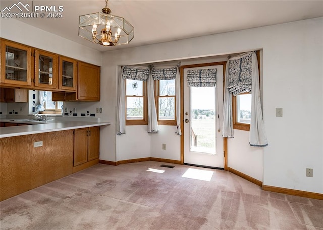 6185 Sayres Rd, Colorado Springs, CO 80927 - kitchen featuring brown cabinetry, baseboards, visible vents, and an inviting chandelier