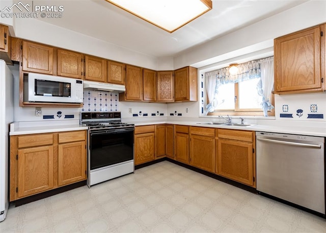 6185 Sayres Rd, Colorado Springs, CO 80927 - kitchen with white microwave, a sink, range with gas stovetop, light floors, and stainless steel dishwasher