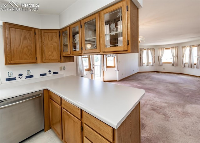 6185 Sayres Rd, Colorado Springs, CO 80927 - kitchen featuring brown cabinetry, light colored carpet, stainless steel dishwasher, a peninsula, and open floor plan