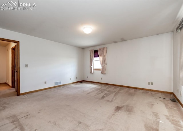 6185 Sayres Rd, Colorado Springs, CO 80927 - spare room with visible vents, baseboards, and light carpet