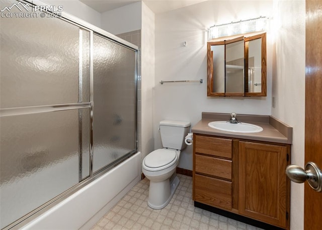 6185 Sayres Rd, Colorado Springs, CO 80927 - full bath featuring toilet, tile patterned floors, combined bath / shower with glass door, and vanity