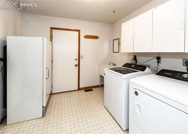 6185 Sayres Rd, Colorado Springs, CO 80927 - laundry room with cabinet space, washer and clothes dryer, and light floors