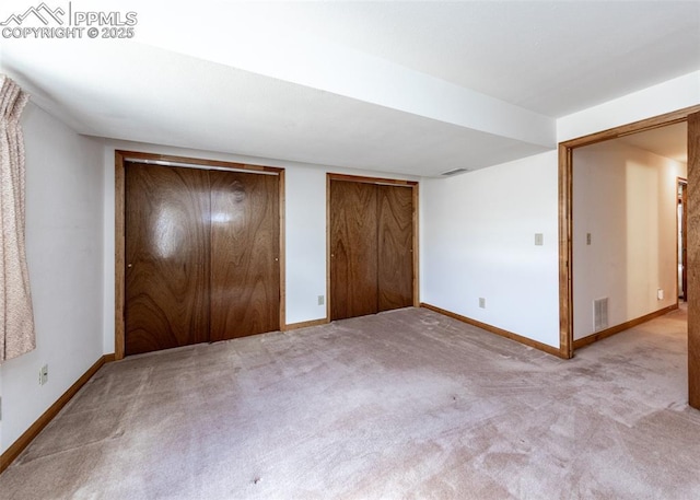 6185 Sayres Rd, Colorado Springs, CO 80927 - unfurnished bedroom featuring baseboards, two closets, carpet flooring, and visible vents