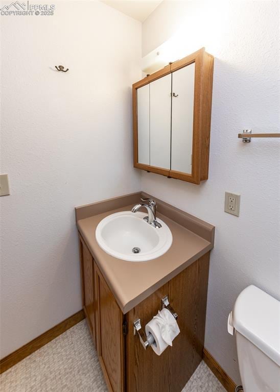 6185 Sayres Rd, Colorado Springs, CO 80927 - half bathroom featuring vanity, baseboards, and toilet