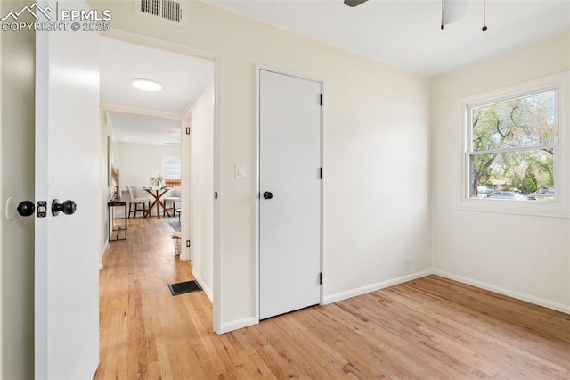 unfurnished bedroom featuring visible vents, multiple windows, and light wood-type flooring