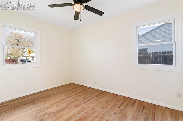 unfurnished room featuring baseboards, light wood-style flooring, and ceiling fan