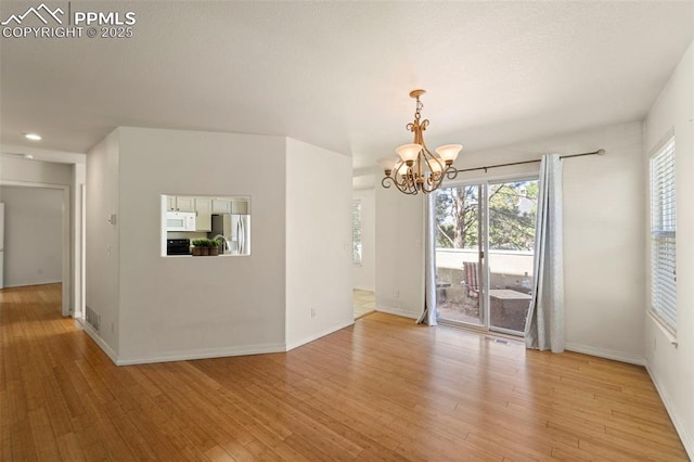 3245 Chestnut Glen Ln, Colorado Springs, CO 80918 - unfurnished room with a chandelier, light wood finished floors, plenty of natural light, and recessed lighting