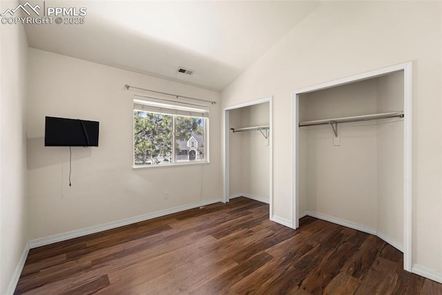 3245 Chestnut Glen Ln, Colorado Springs, CO 80918 - unfurnished bedroom with two closets, dark wood-type flooring, and lofted ceiling
